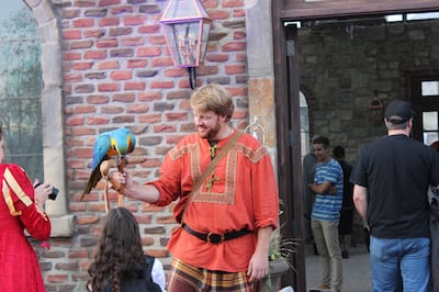Evermore employee Ben Woodruff shows off his parrot to guests on Evermore's opening day, Sept. 29, 2018.