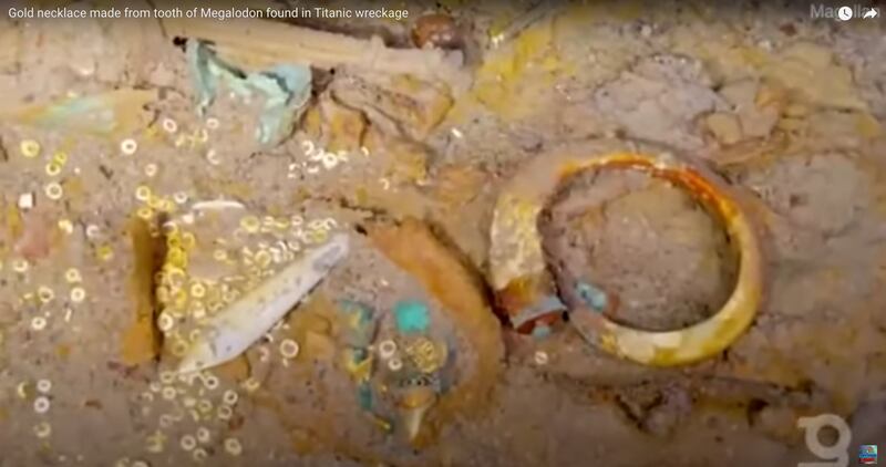 A megalodon tooth necklace is pictured in this video screenshot of the Titanic, captured by Magellan and recently released.