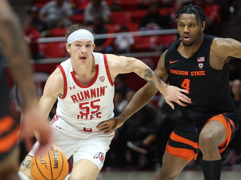 Utah Utes guard Gabe Madsen drives on Oregon State guard Dexter Akanno in Salt Lake City on Thursday, Jan. 5, 2023.