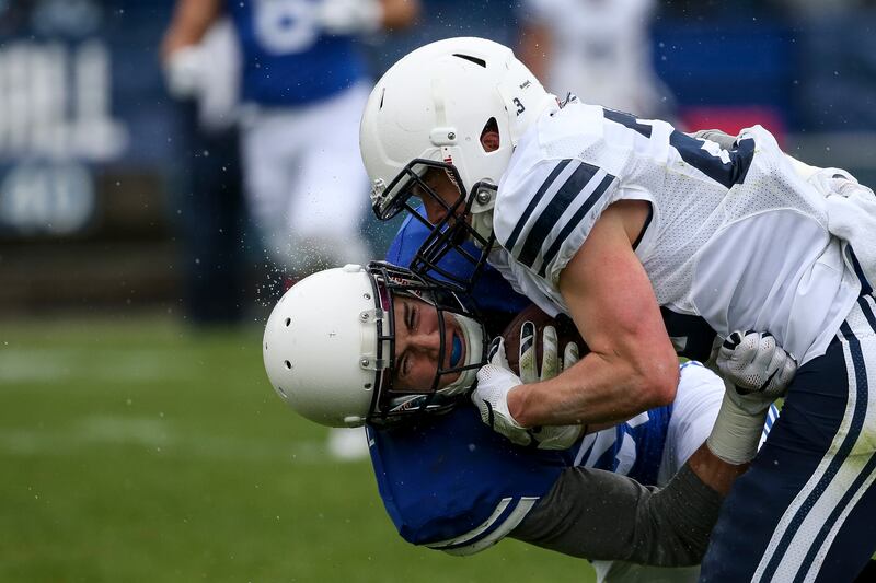 Wide receiver Spencer Romney is tackled by defensive back Sawyer Powell during the BYU football spring practice and scrimmage at LaVell Edwards Stadium in Provo on Saturday, March 25, 2017.