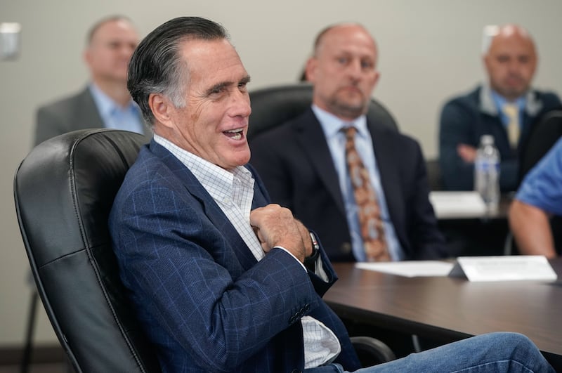 Sen. Mitt Romney, R-Utah, talks to Kenworth Sales employees before a tour of the company in West Valley City