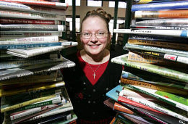 Patricia Castelli, a children's librarian at the Orem City Library, stands by her 100 favorite children's books from the 21st century.
