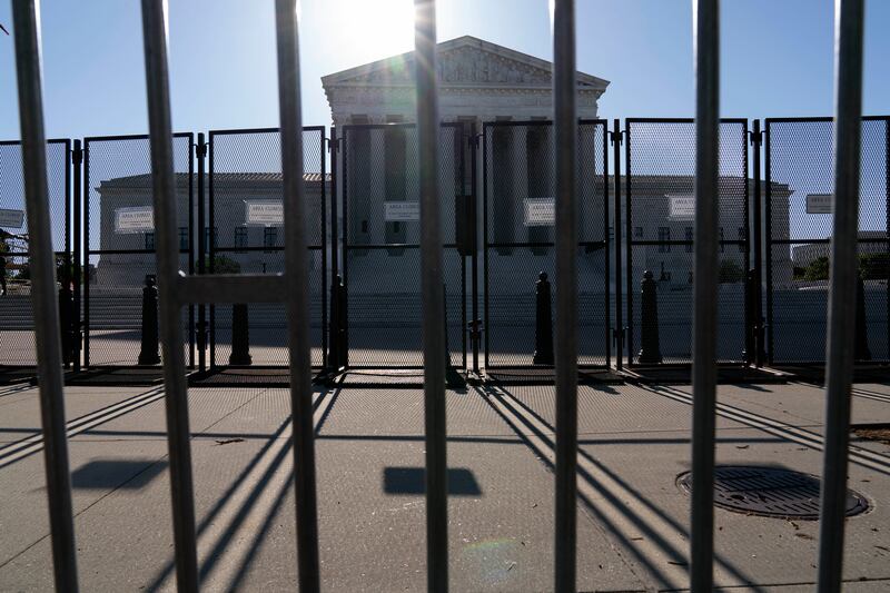 An anti-scaling fence is seen outside of the U.S. Supreme Court, Tuesday, May 10, 2022 in Washington.