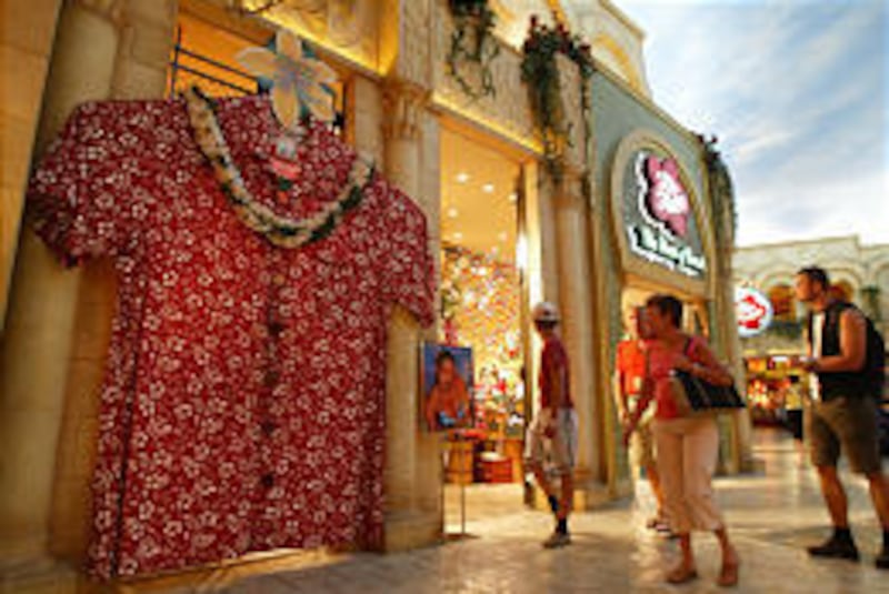 Shoppers at the Desert Passage Mall at the Aladdin Hotel and Casino in Las Vegas walk past a giant aloha shirt at the Hawaiian-themed Hilo Hattie store.