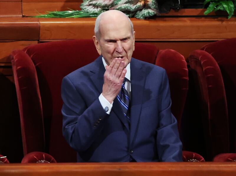 President Russell M. Nelson blows a kiss to attendees during a session of General Conference.