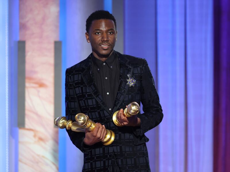 Jerrod Carmichael holding three Golden Globes during the 80th annual Golden Globe Awards.