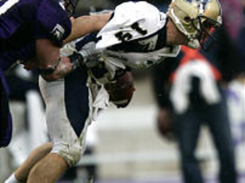 Montana State quarterback Travis Lulay is dragged down from behind by Weber State defender Tyler DeBry during the Bobcats' 27-24 victory Saturday in Ogden.