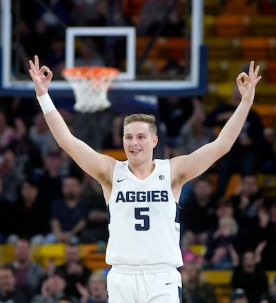 FILE: Utah State guard Sam Merrill celebrates after Brock Miller made a 3-pointer against Fresno State during an NCAA college basketball game Wednesday, Jan. 9, 2019, in Logan, Utah. Merrill had 22 points Saturday as the Aggies went on the road and beat W