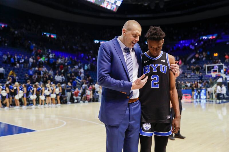 BYU Cougars coach Mark Pope talks to Jaxson Robinson after beating the Weber State Wildcats in Provo on Dec. 22, 2022.