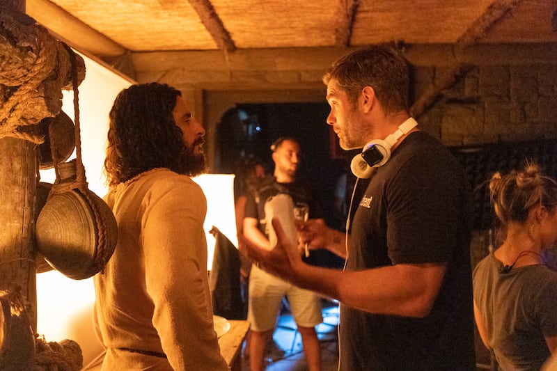 Actor Jonathan Roumie speaks with director Dallas Jenkins while filming Season 3 of “The Chosen.”