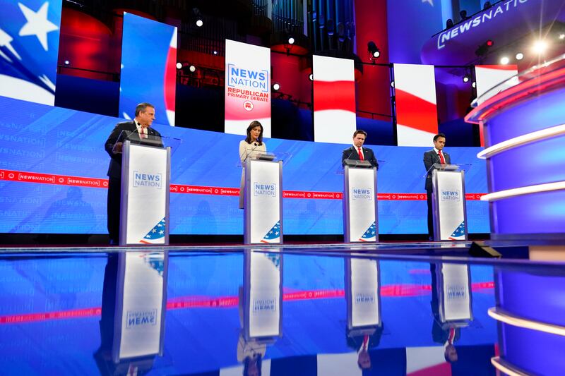 Republican presidential candidates stand at podiums at a presidential primary debate hosted by NewsNation in Alabama.