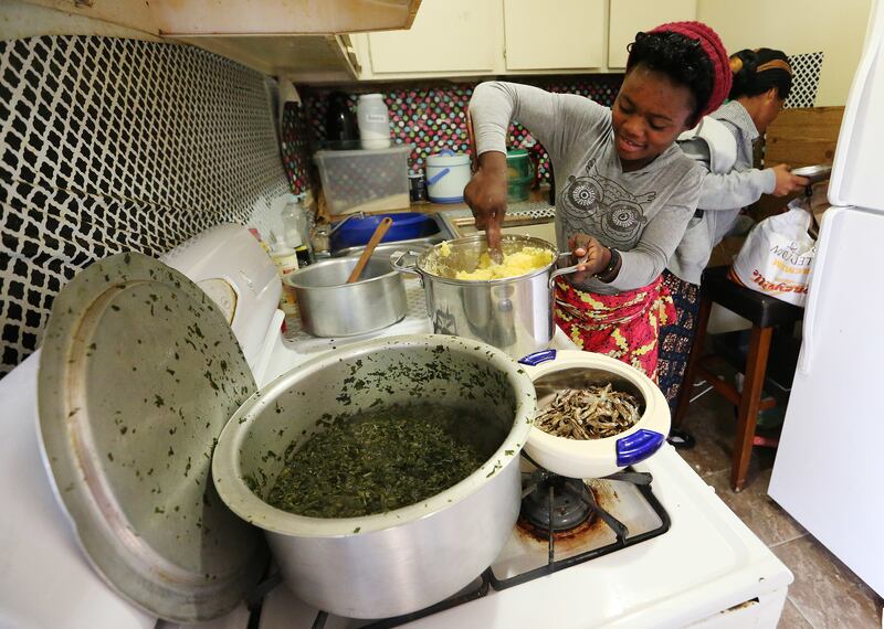 Congolese refugee Stamili Ngunza, 18, prepares dinner for the family at their home in Salt Lake City on Nov. 5, 2017.