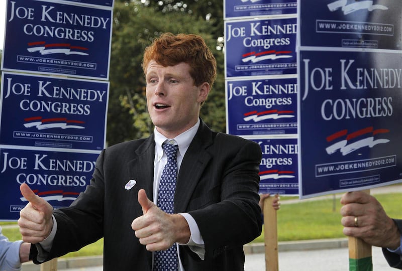 Joseph Kennedy III, son of former U.S. Rep. Joseph P. Kennedy II and grandson of the late Robert F. Kennedy gestures while visiting voters outside a polling station at a school in Needham, Mass., Thursday, Sept. 6, 2012. The 31-year-old Kennedy is vying f