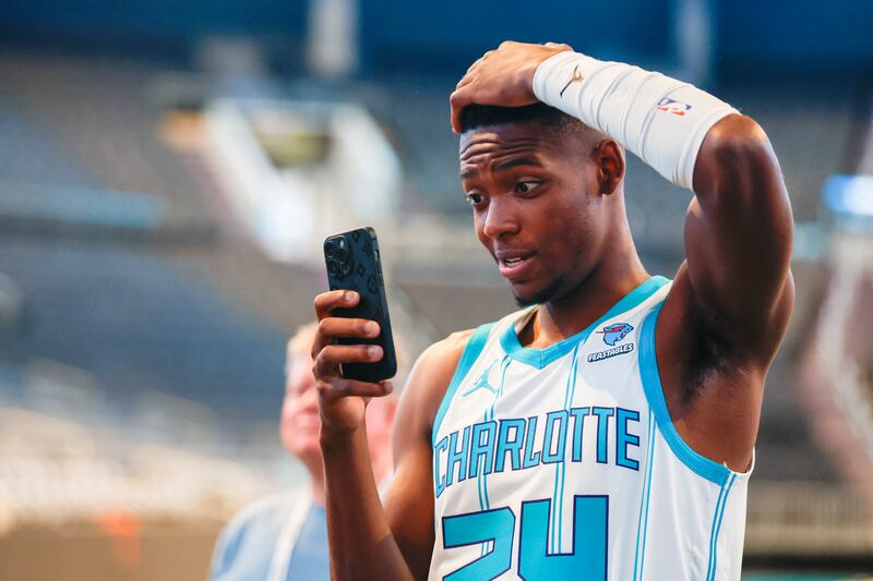 Charlotte Hornets forward Brandon Miller takes a photo with his phone on Oct. 2, 2023.