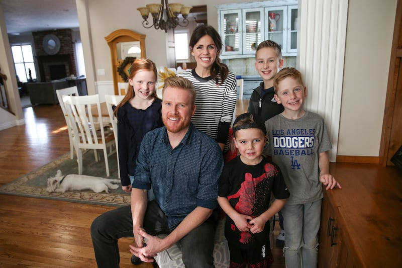 Scott and Mickell Warner and their children, Tessa, 10, Tommy, 5, Chase, 12, and Luke, 7, left to right, pose for a photo at their home in Orem on Wednesday, Jan. 24, 2018.