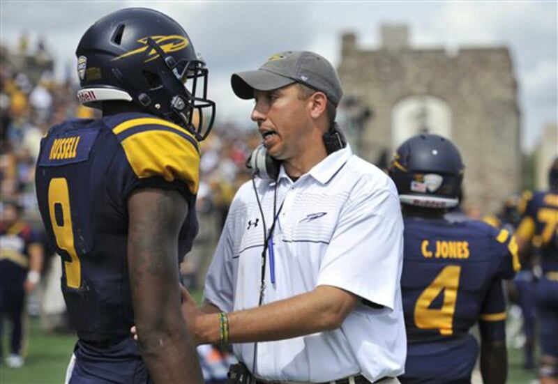 Toledo Rockets head coach Matt Campbell, right, talks to wide receiver Alonzo Russell (9) at halftime of an NCAA college football game against the Missouri Tigers in Toledo, Ohio, Saturday, Sept. 6, 2014. Missouri won 49-24.
