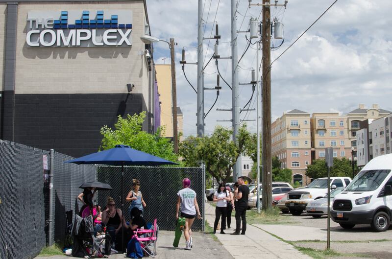 People wait in line for a rock concert scheduled to begin at 6:30 p.m. at the Complex on Friday, July 28, 2017.