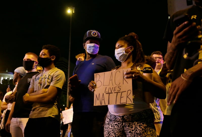 Protesters stand in downtown Columbus, Ohio, Thursday, May 28, 2020, during a demonstration over the death of George Floyd in police custody Monday in Minneapolis.