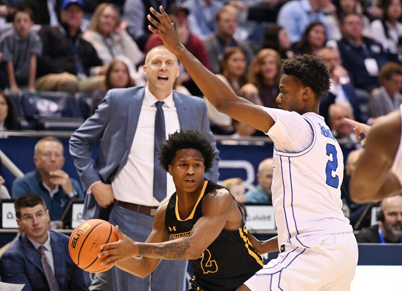 BYU guard Jaxson Robinson (2) defends Southeastern Louisiana Lions guard Roscoe Eastmond (2) as Cougars coach Mark Pope watches from the sidelines at the Marriott Center in Provo on Wednesday, Nov. 15, 2023.