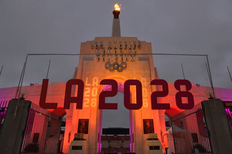 An LA2028 sign is seen in front of a blazing Olympic cauldron at the Los Angeles Memorial Coliseum on Wednesday, Sept. 13, 2017.