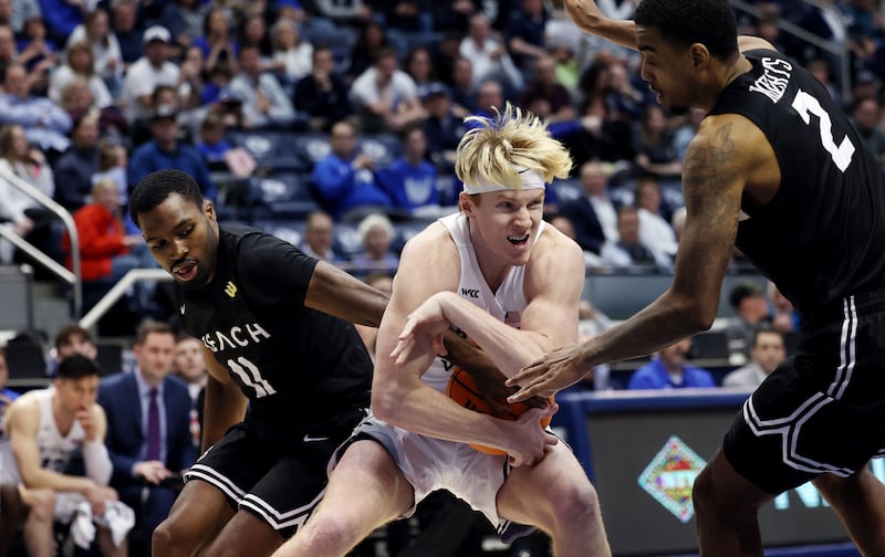 Brigham Young Cougars guard Hunter Erickson (0) wrestles for the ball with Long Beach State 49ers guard Joel Murray (11) and Long Beach State 49ers forward Jordan Roberts (2) during an NIT game at the Marriott Center in Provo on Wednesday, March 16, 2022. BYU won 93-72.