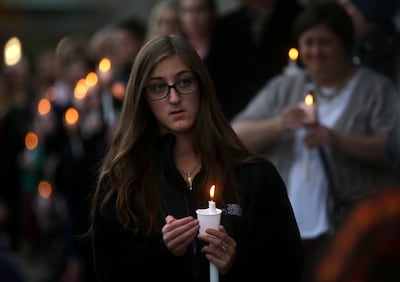 Shayna Silk carries a candle during a vigil and prayer service for all those impacted by the shooting at the Tree of Life Synagogue in Pittsburgh, outside of Chabad Lubavitch of Utah in Salt Lake City on Monday, Oct. 29, 2018.