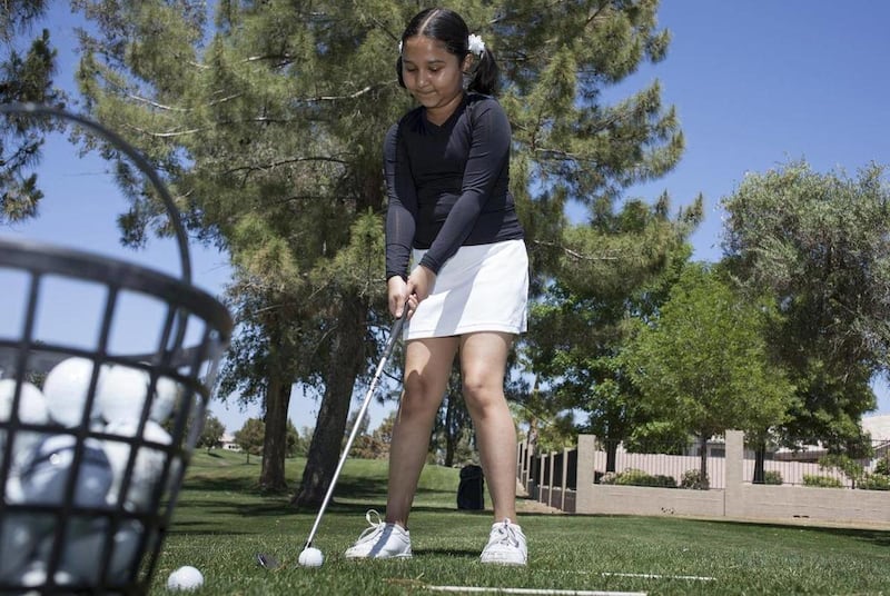 In this April 20, 2012 photo, Ria Cheruvu practices during golf lessons at Ocotillo Golf Resor in Chandler, Ariz. At 8 years old, Ria, can't make up her mind whether she should become a software engineer like her parents or the president of the United Sta