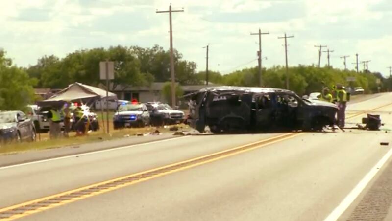This frame grab from video provided by KABB/WOAI in San Antonio shows the scene where authorities say at least five people are dead and several others hurt as an SUV carrying more than a dozen people crashed, Sunday, June 17, 2018, in Big Wells, Texas, wh