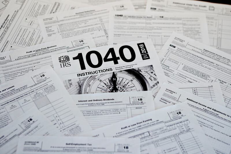 This Feb. 13, 2019, photo shows multiple forms printed from the Internal Revenue Service web page that are used for 2018 U.S. federal tax returns in Zelienople, Pa. For those scrambling to finish their tax returns on time, the United States post offices w