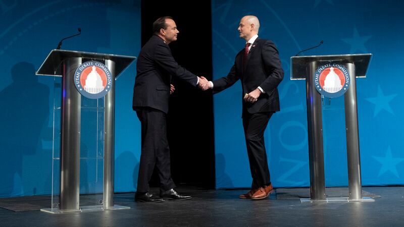 Sen. Mike Lee, R-Utah, and Evan McMullin, U.S. Senate candidate, shake hands at a debate at Utah Valley University.