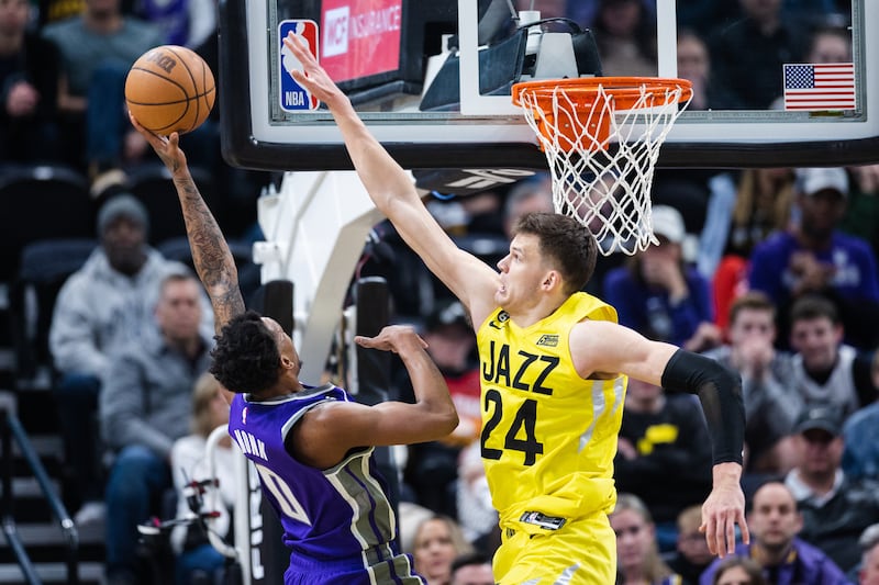 Utah Jazz center Walker Kessler jumps to block a shot attempt by Sacramento guard Malik Monk during a game against Sacramento.