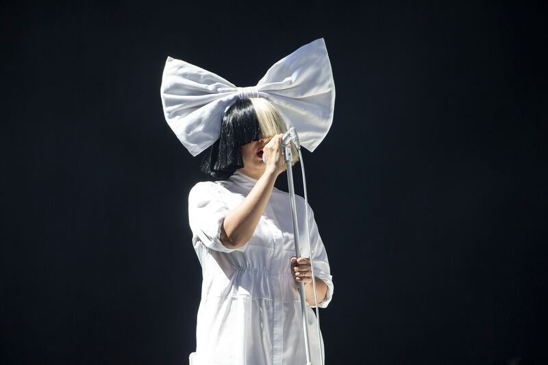 In this Aug 20, 2016 file photo, Sia performs as part of the V Festival in Hylands Park, Chelmsford. Sia has given Rebeca Godoy, a Mexican fan with terminal cancer, permission to record one of her songs for a video with the profits to be donated to cancer research.