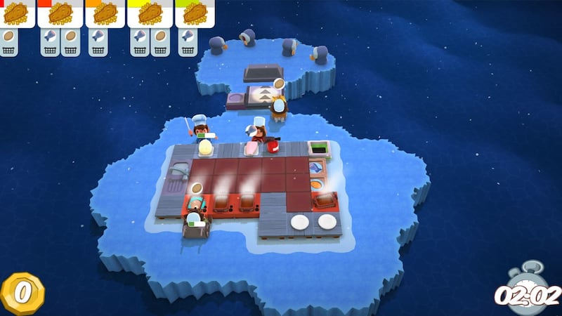 Four chefs work together to complete food orders in a timely manner on an iceberg in "Overcooked!"