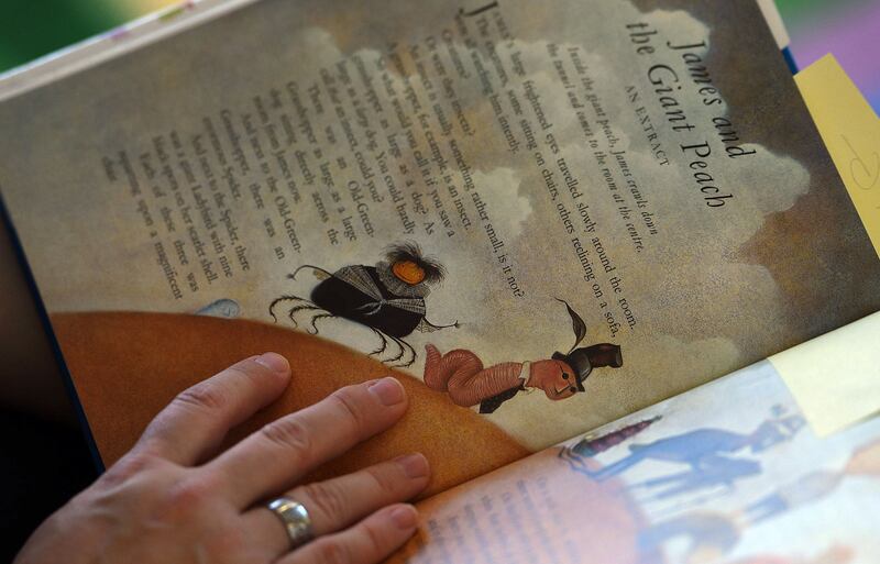 A storyteller reads an excerpt from “James and the Giant Peach” in West Jordan on Oct. 7, 2016.