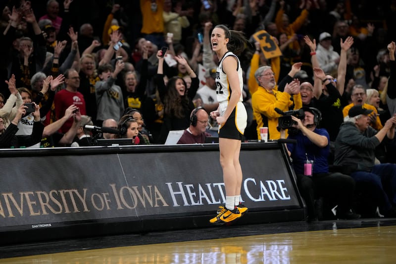 Iowa guard Caitlin Clark (22) reacts after breaking the NCAA women’s career scoring record.