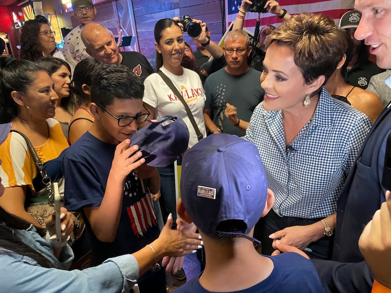 Kari Lake, former TV anchor, greets supporters as she campaigns for governor of Arizona.