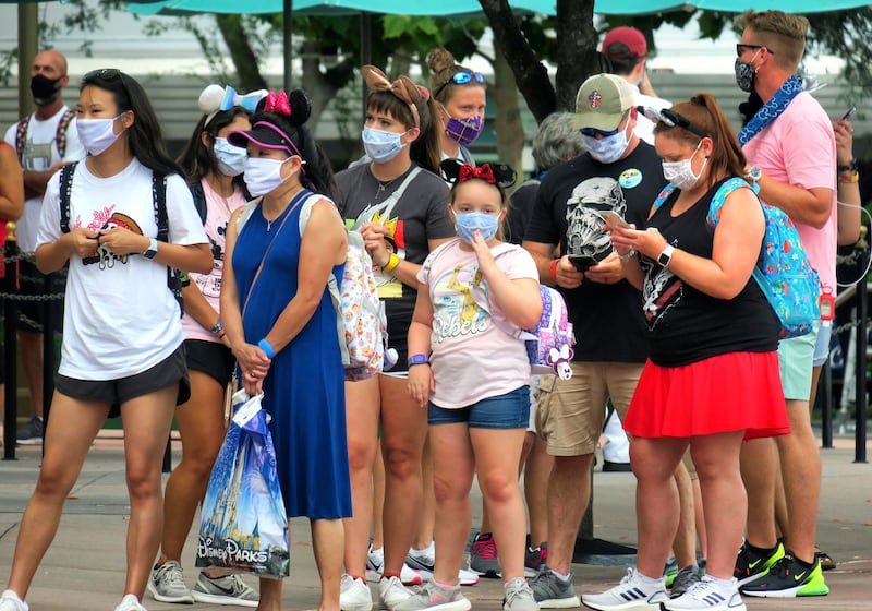 Guests wait in line to ride Mickey and Minnie’s Runaway Railway attraction on the second day of the re-opening of Disney’s Hollywood Studios at Walt Disney World, in Lake Buena Vista, Fla., Thursday, July 16, 2020.