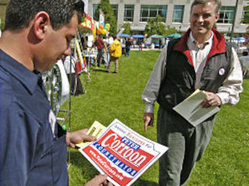 County mayoral candidate Peter Corroon, right, talks with Juan Canseco while drumming up support at the Hispanic Festival at the Gallivan Center Saturday.