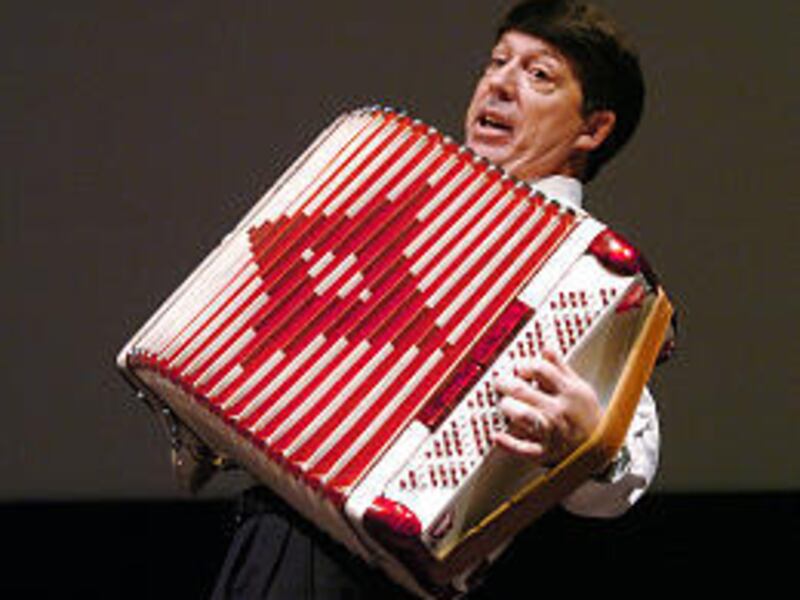 Jeffrey Sermon shows his BYU Education Week audience how he played his accordian when he was a youth.