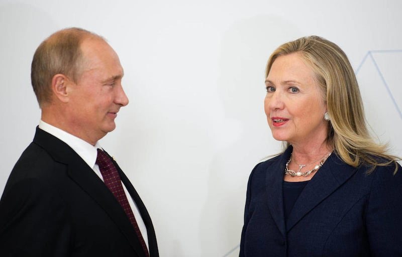 In this Sept. 8, 2012 file photo, U.S. Secretary of State Hillary Rodham Clinton, right, talks with Russian President Vladimir Putin during the arrival ceremony for the Asia-Pacific Economic Cooperation (APEC) Summit in Vladivostok, Russia.