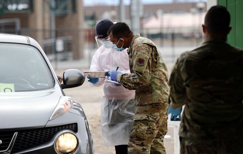 Workers take down information from residents as they receive COVID-19 tests at the Utah State Fairpark in Salt Lake City on Friday, Feb. 26, 2021. Experts suggest the US has seen a plateau in COVID-19 case numbers. This might be a problem