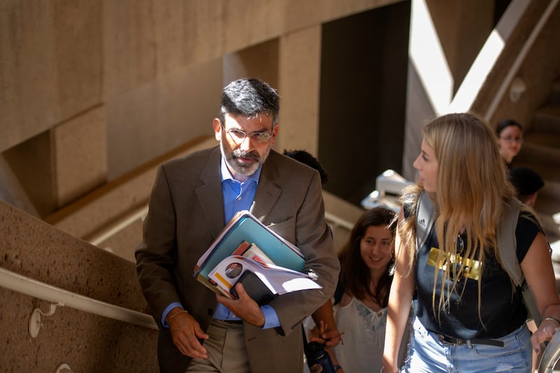 Arizona State student Courtney Langerud, right, of San Diego, talks with professor Paul Carrese on Thursday, Aug. 16, 2018, after a "Political Thought: Islam, Hinduism and Confucianism" class at ASU in Tempe, Arizona.