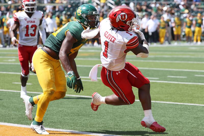 Utah running back Jaylon Glover scores a touchdown past Baylor linebacker Brooks Miller.