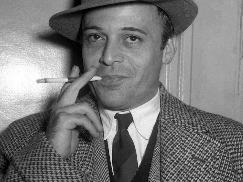 FILE - An Oct. 28, 1955 photo from files showing British actor Herbert Lom at London Airport prior to his departure to Rome, to continue filming 'War and Peace'. The Czech-born actor who starred as Inspector Clouseau's boss in the Pink Panther movies, has