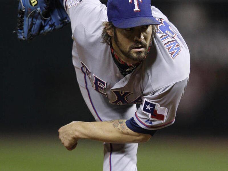 Texas Rangers' C.J. Wilson throws during the sixth inning of Game 7 of baseball's World Series against the St. Louis Cardinals Friday, Oct. 28, 2011, in St. Louis.