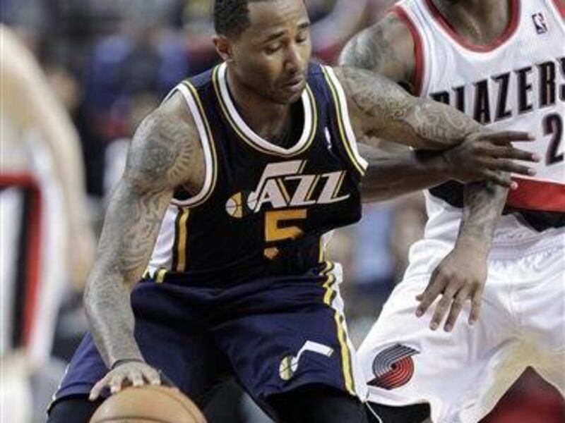 Utah Jazz guard Mo Williams, left, holds off Portland Trail Blazers guard Wesley Matthews while dribbling during the second half of an NBA basketball game in Portland, Ore., Friday, March 29, 2013. Williams led the Jazz in scoring with 28 points as they
