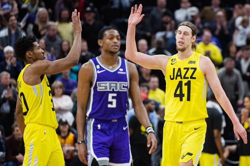 Utah Jazz forward Kelly Olynyk high-fives teammate Ochai Agbaji (30) as Sacramento guard De’Aaron Fox walks away.