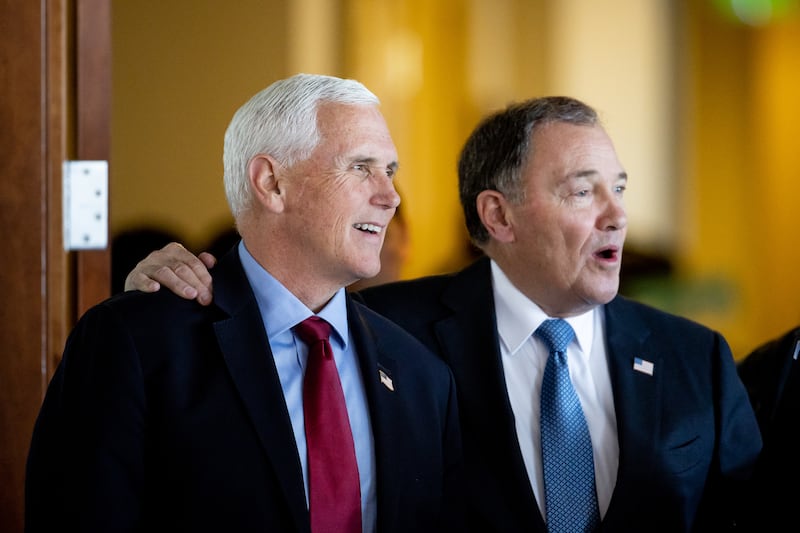 Former Vice President Mike Pence stands with former Gov. Gary Herbert at an event at the Zions Bank Building in Salt Lake City on April 28, 2023.