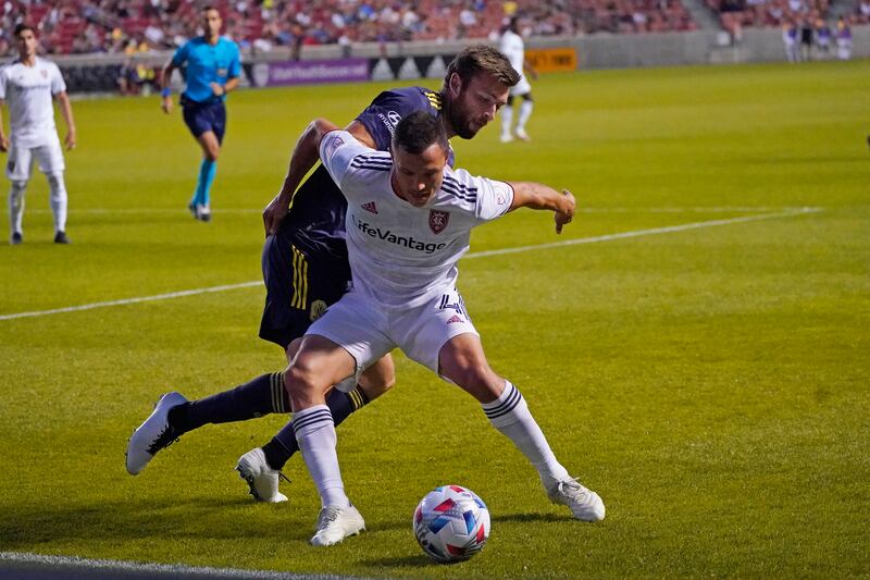 Real Salt Lake’s Ddonny Toia and Nashville SC’s Dave Romney battle for the ball during an MLS game on May 15, 2021.