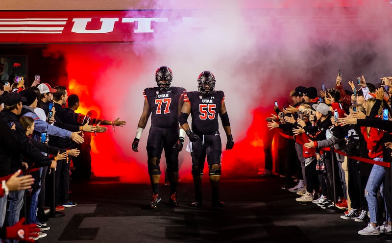 Utah Utes offensive lineman Bamidele Olaseni (77) and Nick Ford (55) lead the team to the field before a game against UCLA.